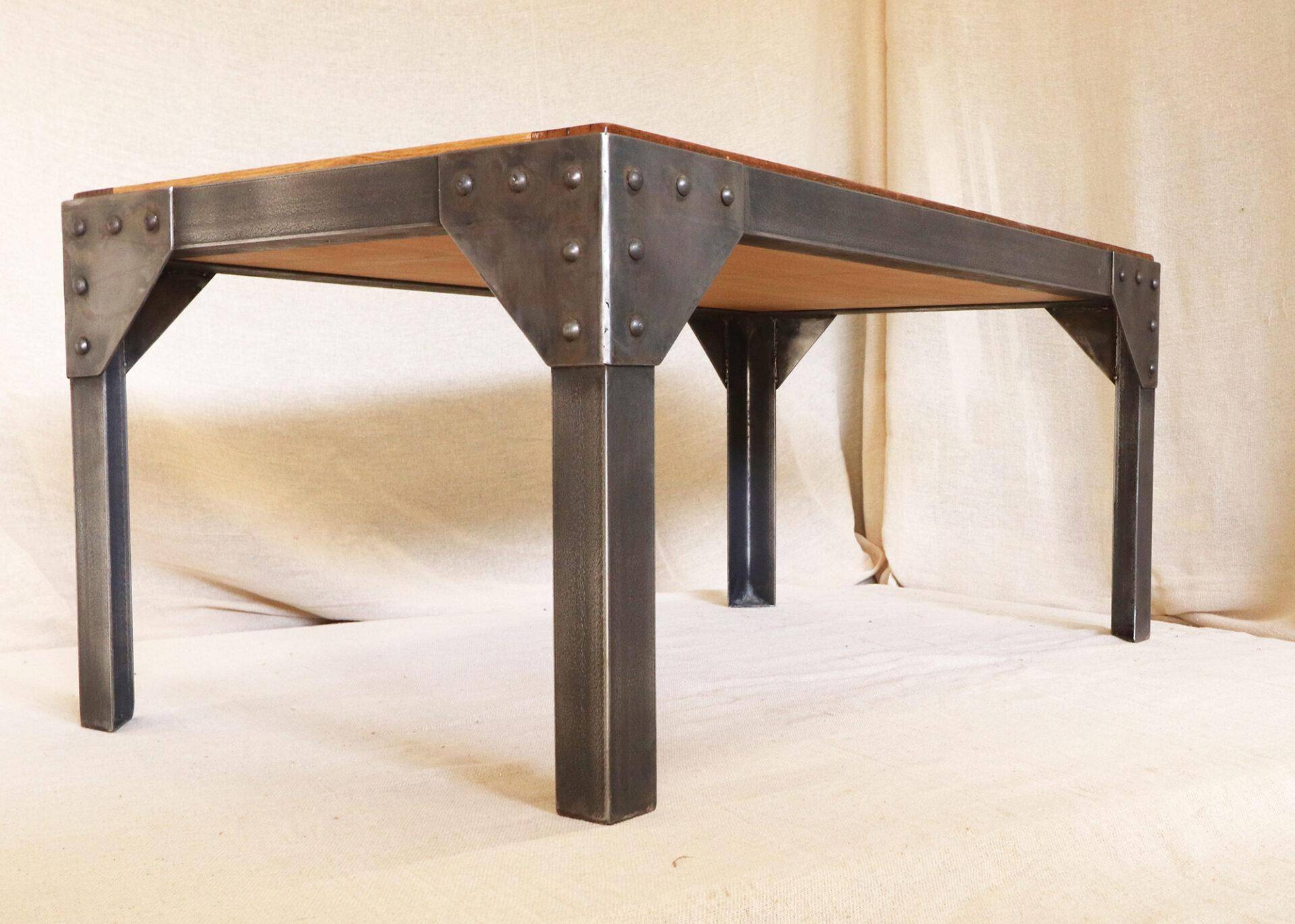 Metal frame coffee table with a reclaimed oak and teak top